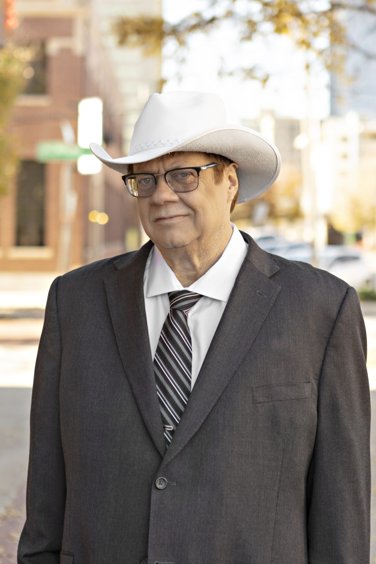 A man in a suit and cowboy hat.